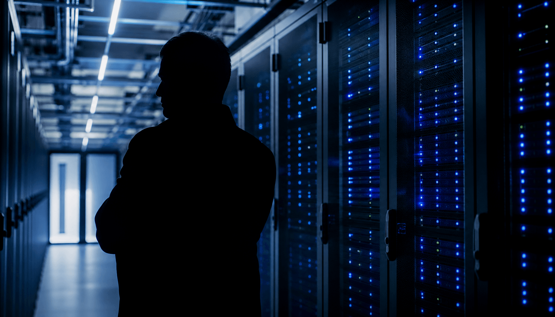 A modern, high-tech data center interior with server racks and blue LED lights, partially obscured b
