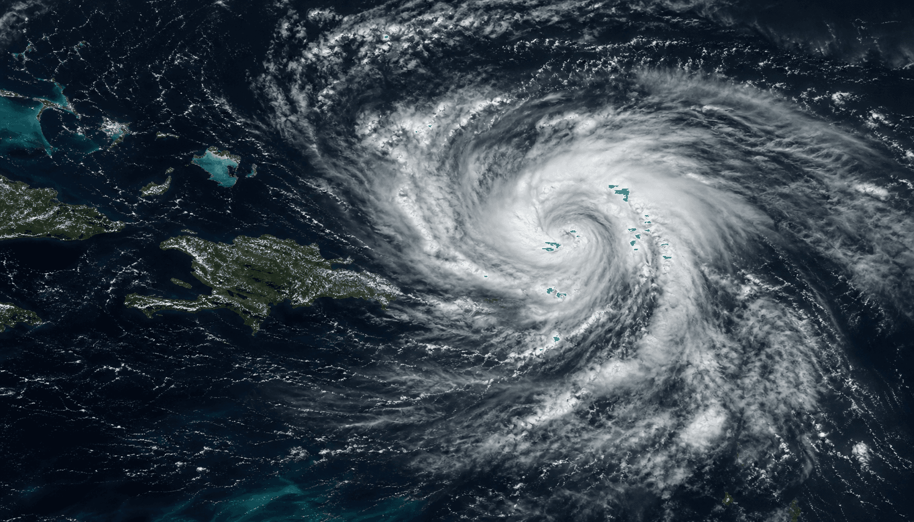 A satellite view of a tropical depression swirling over the ocean near island chains, stormy clouds,