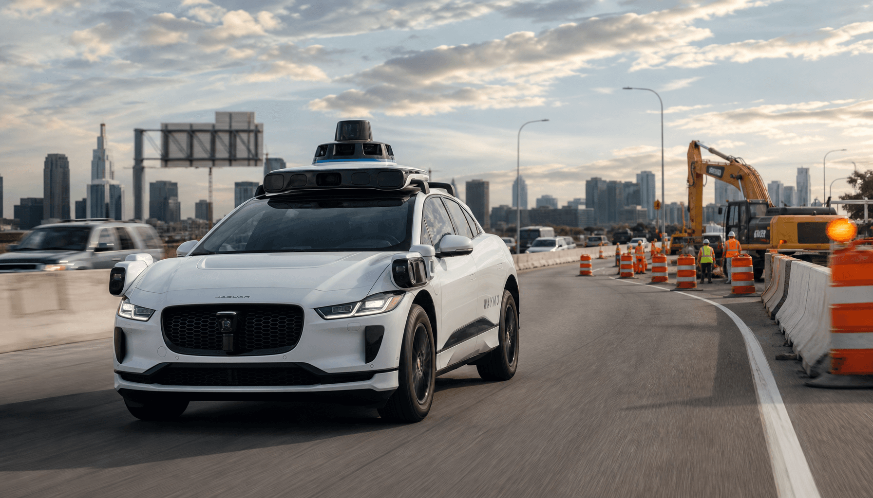 A Waymo robotaxi driving on a highway near a construction zone with orange cones, cinematic shot, re